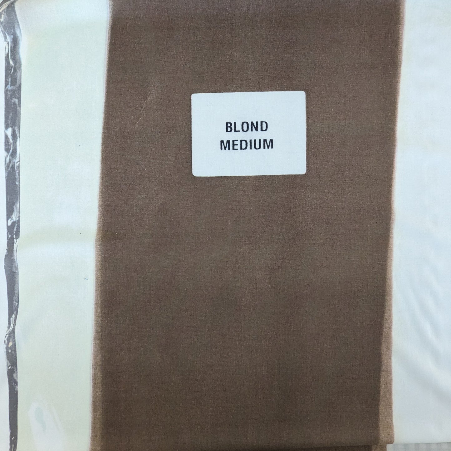 Celine deadstock wool jersey fabric in blonde medium, folded with a label.