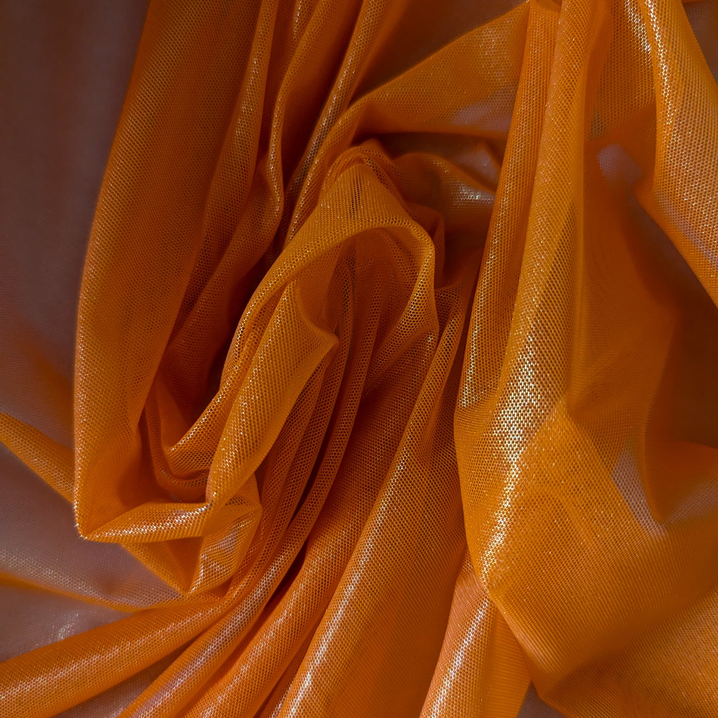 Tangelo orange G###i deadstock fine tulle fabric, 130 cm wide, with a subtle metallic sheen.