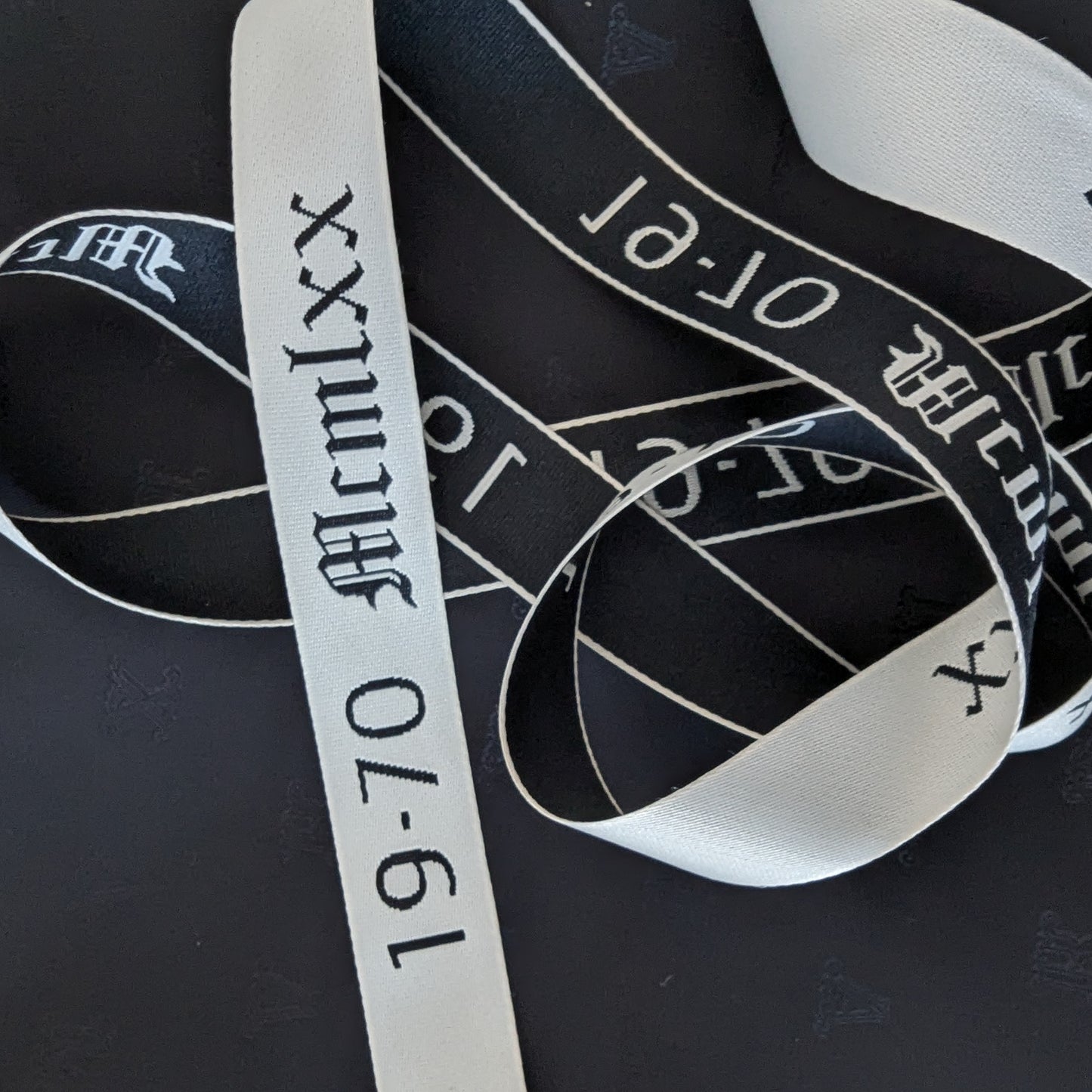 Black and white S*venty V*nezia webband trim with "19-70 McmLxx" text, 100 cm.