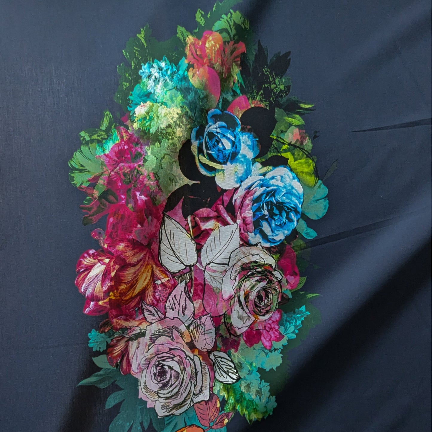 Deadstock denim panel with vibrant multicolored floral print on a dark background.