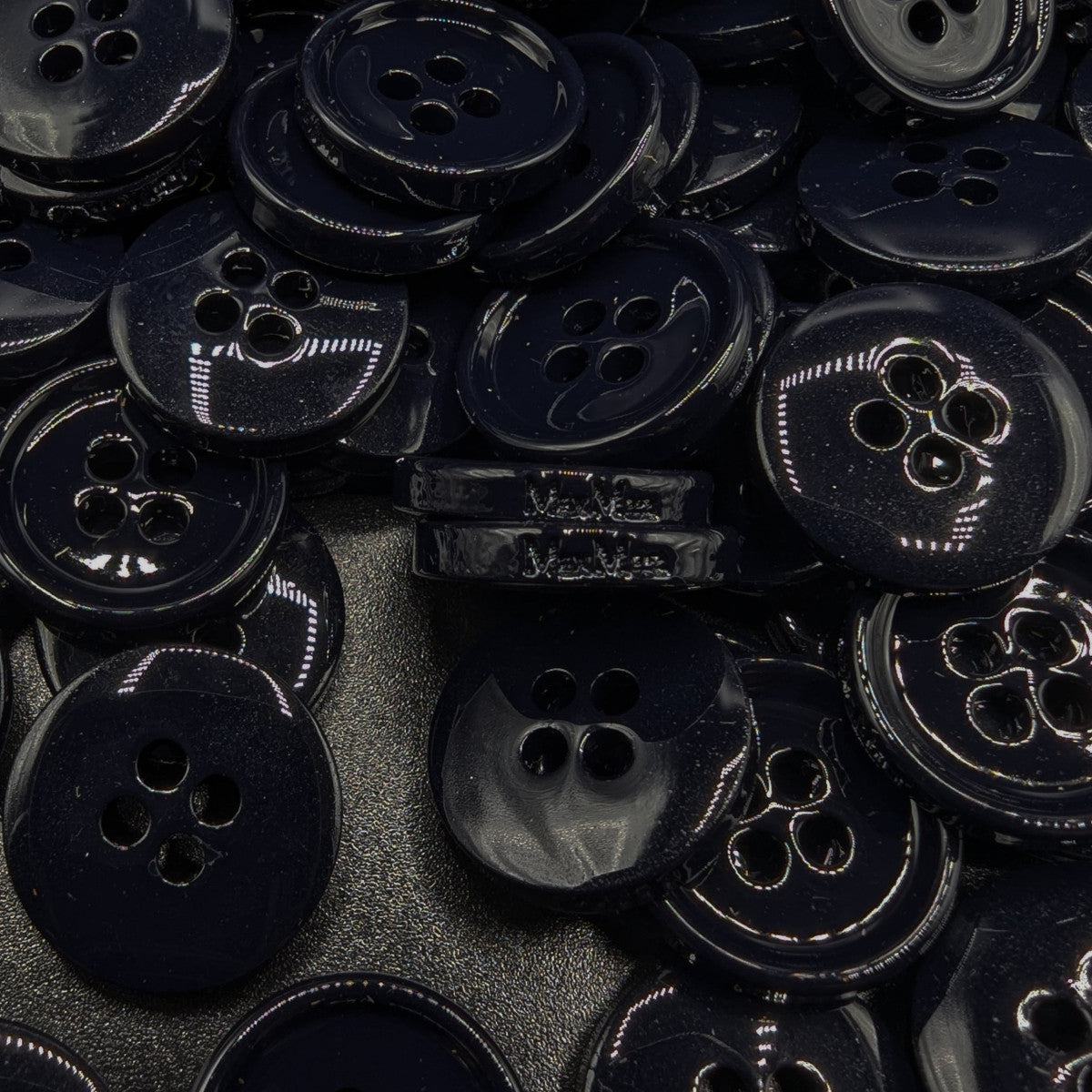 Pile of glossy dark blue 1.6cm 4-hole Max Mara Weekend buttons.