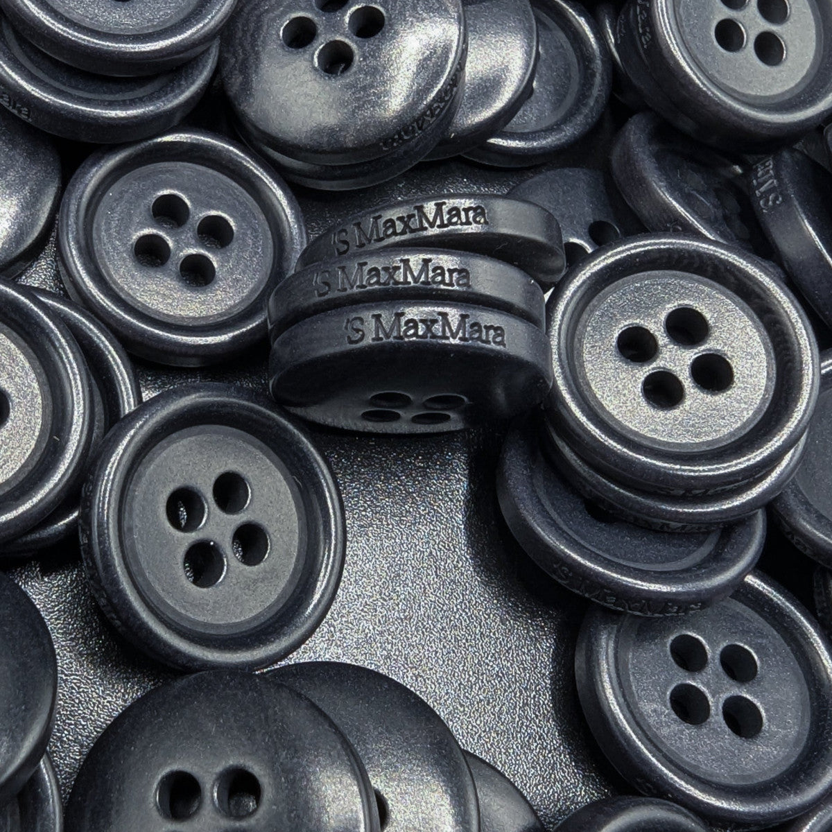Dark grey 1.4cm Max Mara 4-hole buttons, smooth and polished, for coats or cardigans.