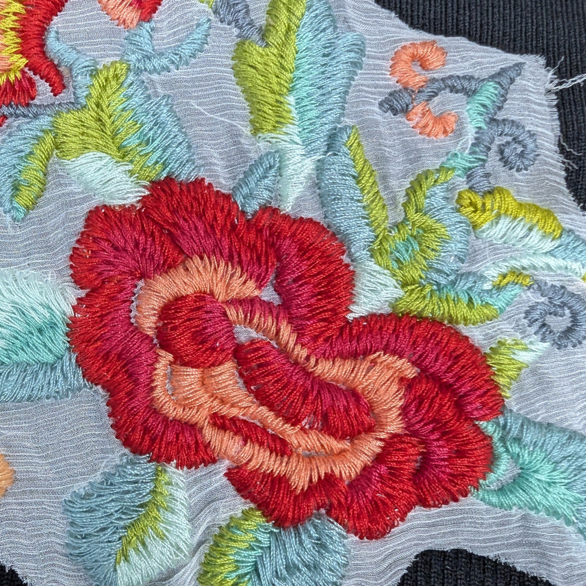 Vibrant G*cci XXL rose embroidery patch with red, orange, green, and blue floral design on fabric.