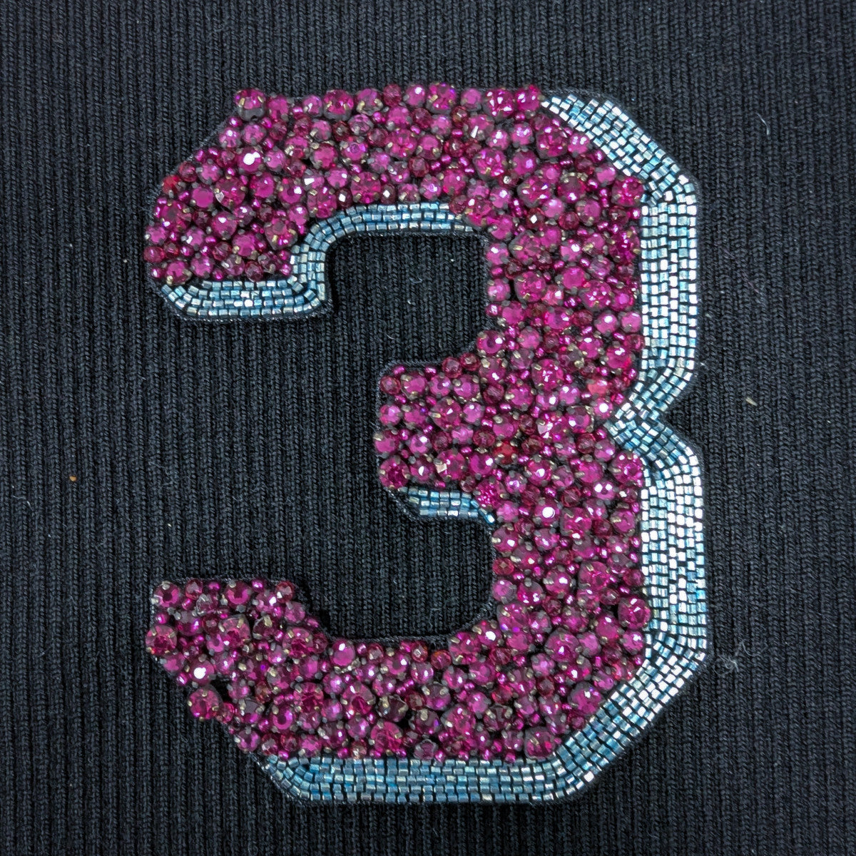 Embroidered D&G number 3 patch, 10cm, with magenta beads and light blue pearl outline on black fabric.