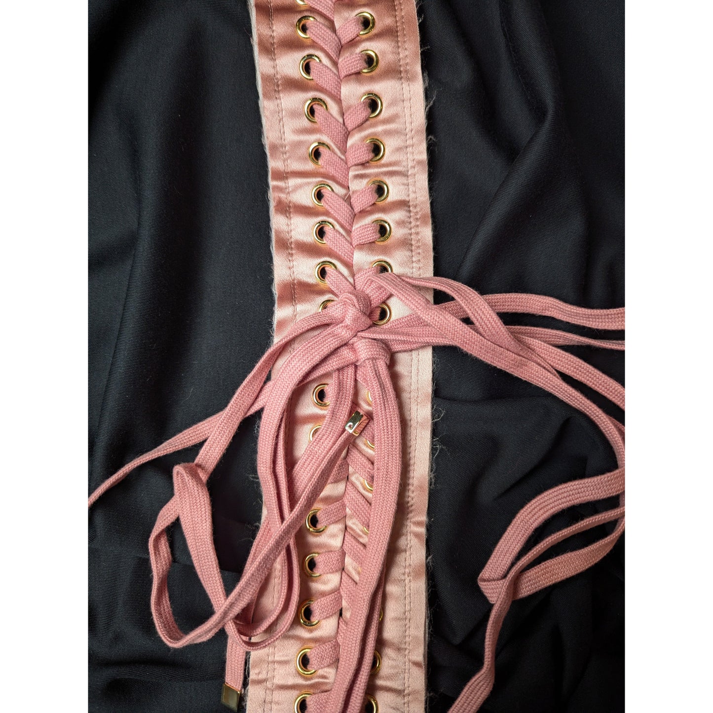 Pink satin D&G deadstock corsage lacing with gold eyelets on black fabric.