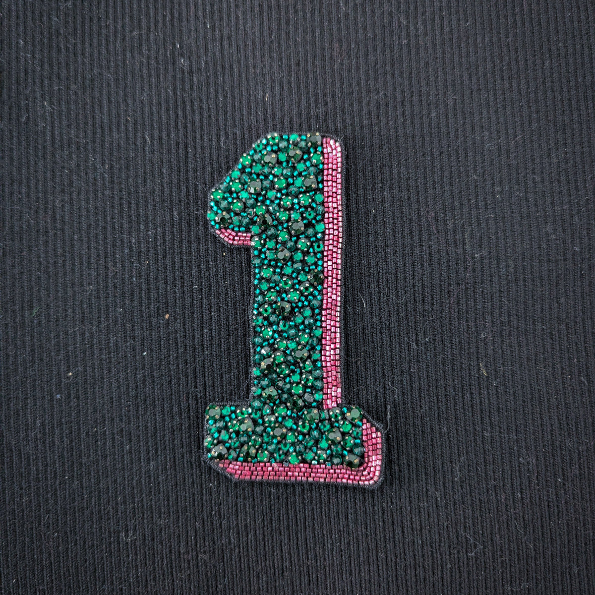 Embroidered D&G "1" patch, 10cm, with green beads and pink pearl trim on black fabric.