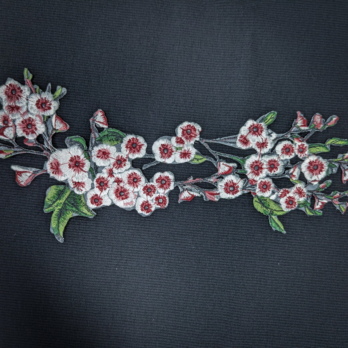 XXL G*cci knitted cherry blossom patch, 40cm, with white and red embroidered flowers and green leaves.