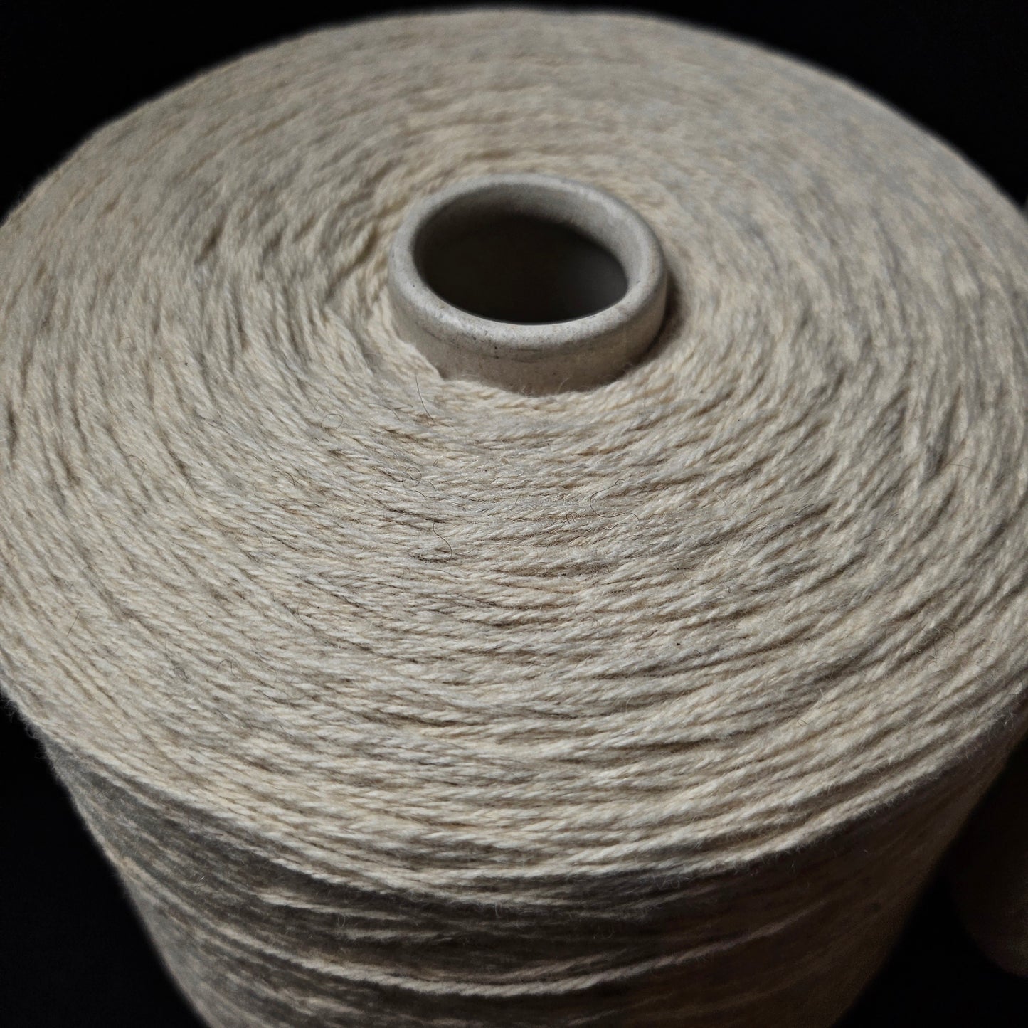 Large cone of natural white 50% yak, 50% merino yarn, 1000g.