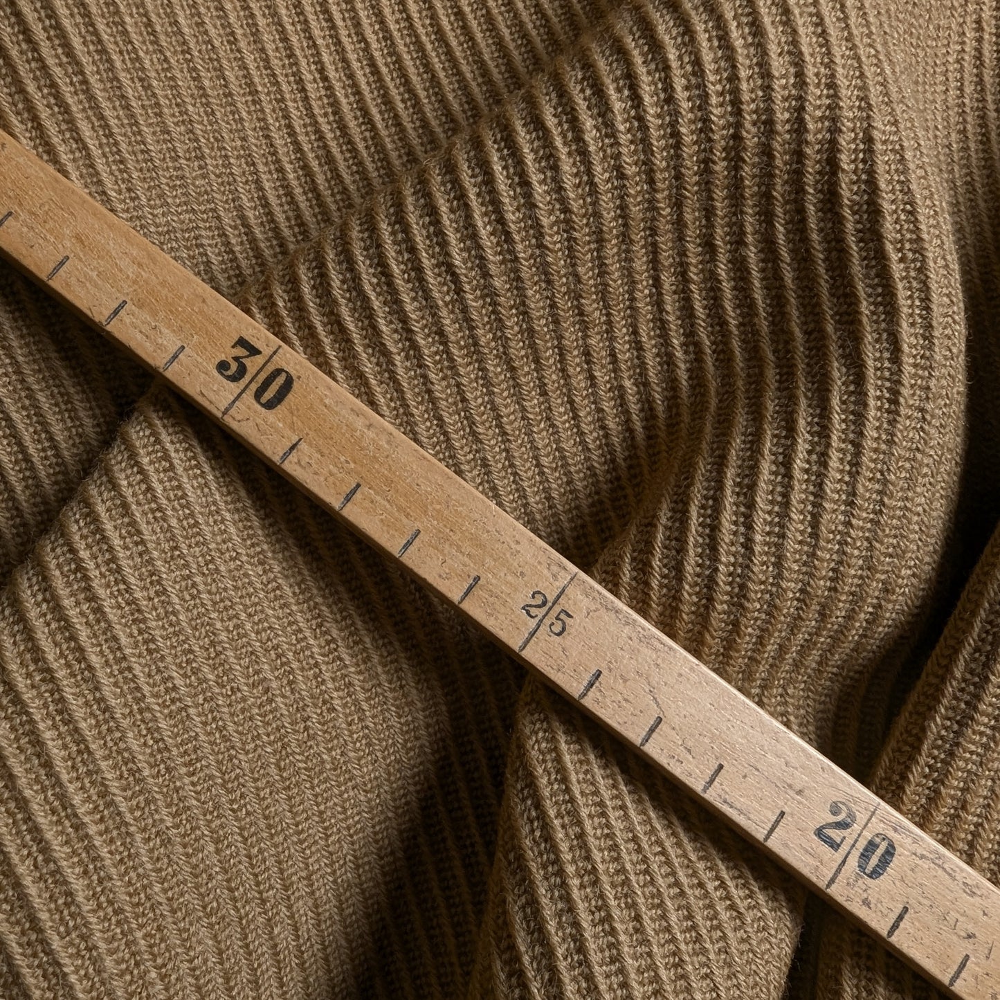 Camel C*line deadstock wool fabric with a textured weave, measured by a wooden ruler.