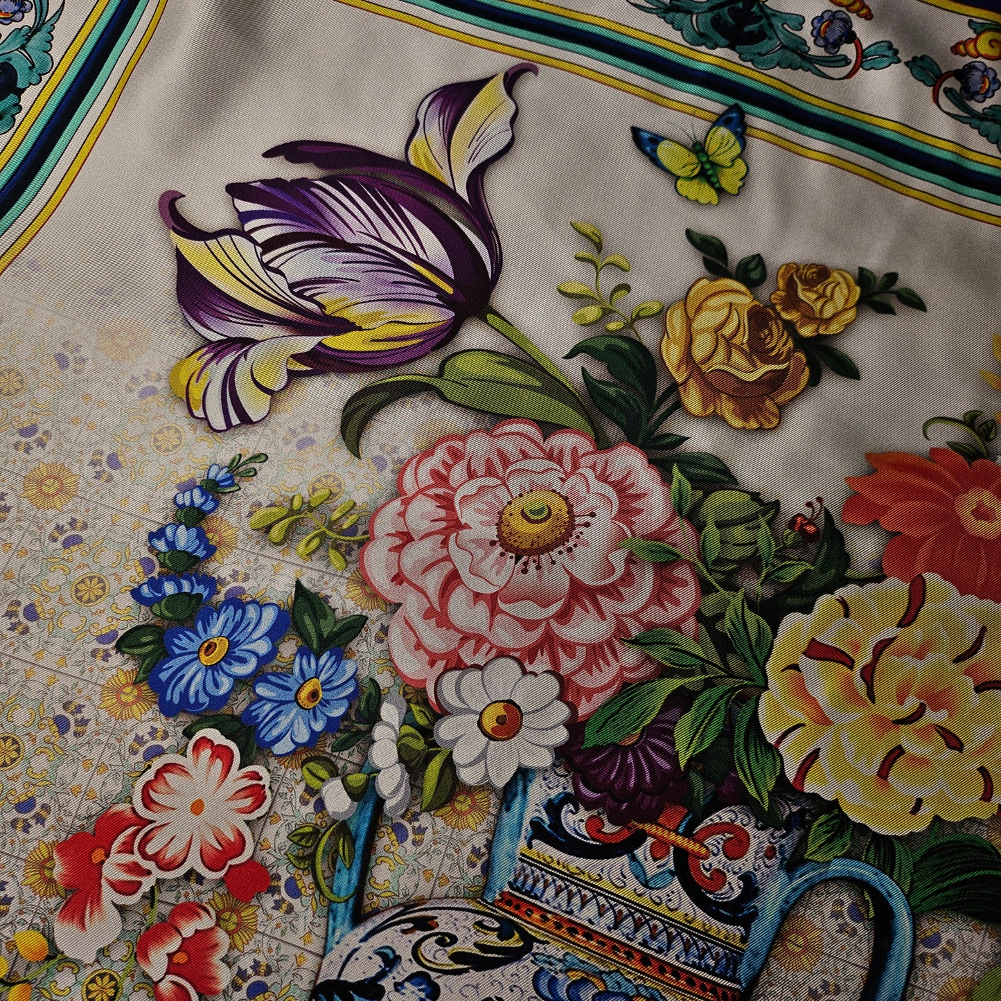 Silk twill scarf, 90x90 cm, with a vibrant classical floral design and a butterfly on a light background.