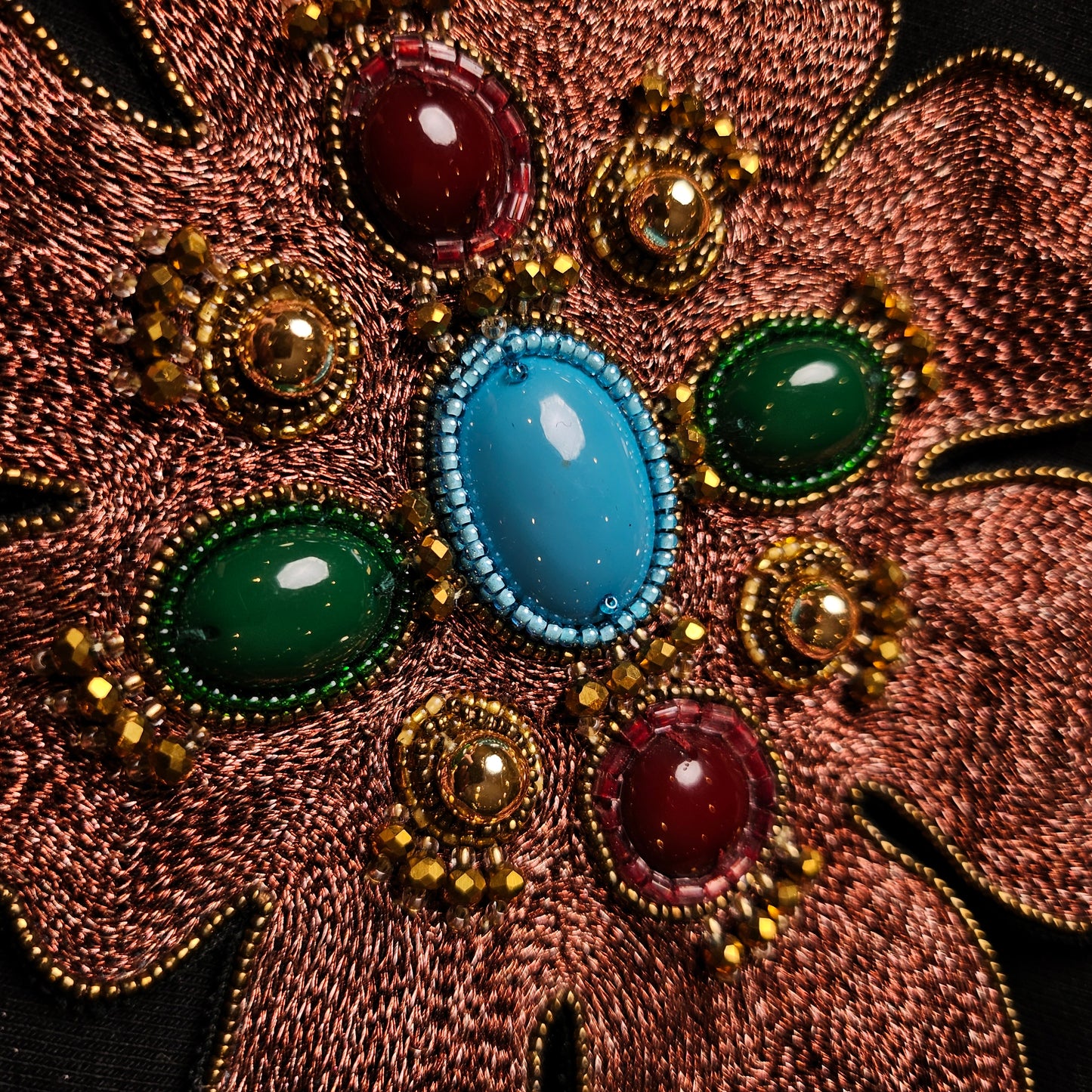 D&G 14x18cm patch with copper-colored embroidery, gold beads, and large red, green, and turquoise gemstones.