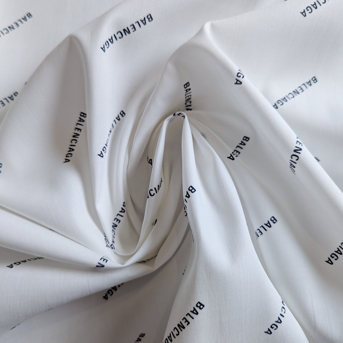 White Balenciaga deadstock cotton poplin fabric with black logo print, 145 cm wide.