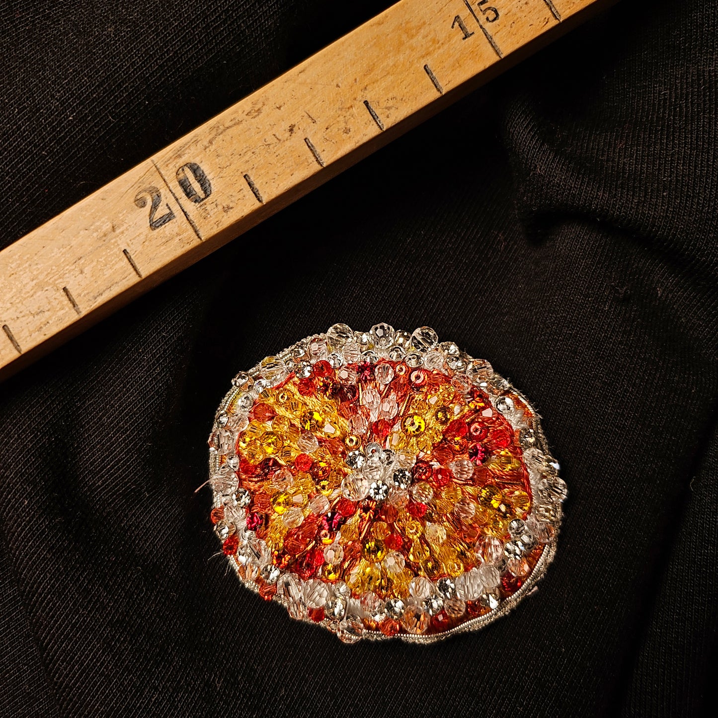 D&G 3D orange fruit patch, 5x6cm, with red, orange, and yellow beads on black fabric.