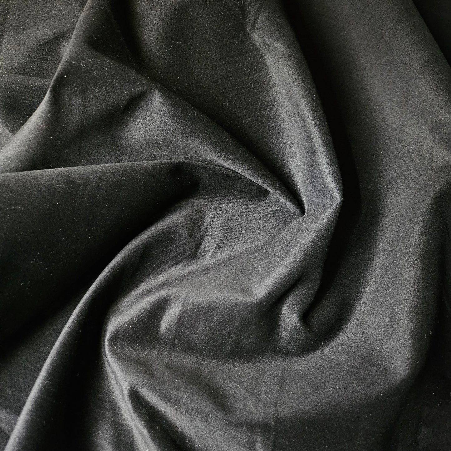 Deadstock black velvet denim fabric, 150cm wide, with soft folds and a subtle sheen.