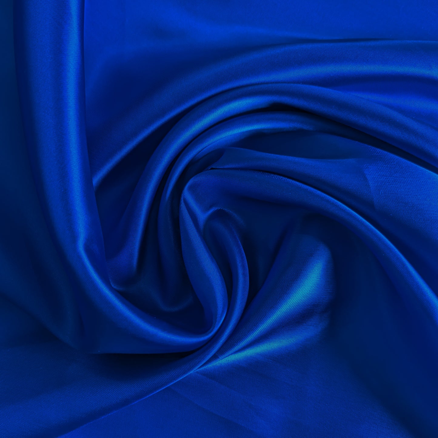 Rich blue Alexander McQueen deadstock viscose lining fabric, fine and glossy, with luxurious folds.
