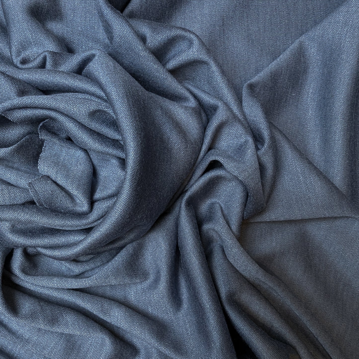 Blaugrau Kaschmir-Seide Jersey Stoff, 130cm breit, with soft drapes and subtle texture.