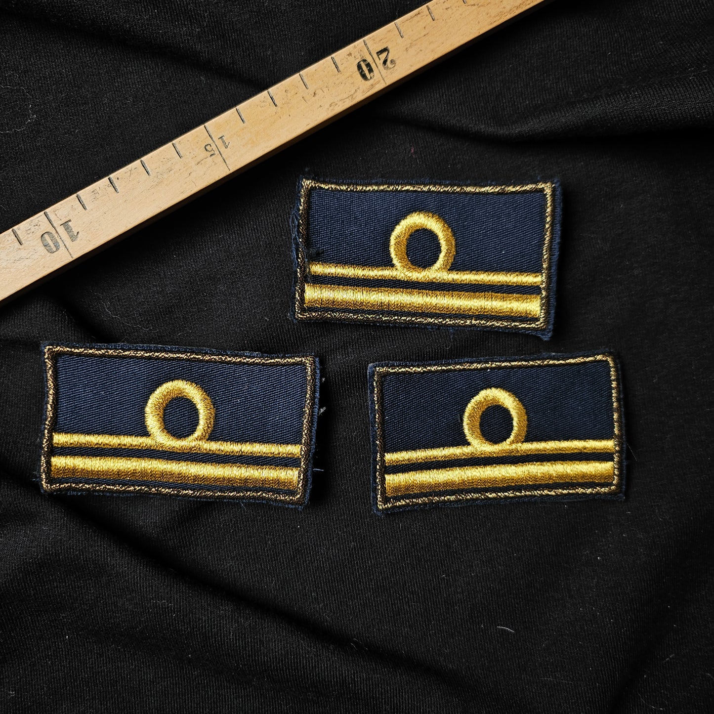 Three navy blue D&G embroidered military rank patches with gold rings and stripes, 4.5x7cm.