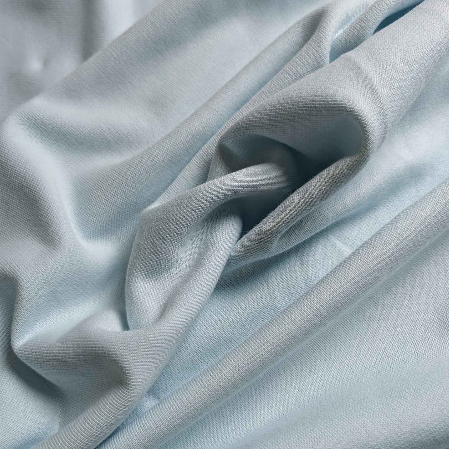 Light blue deadstock wool-viscose fabric, 190 cm wide, with soft drapes and subtle texture.