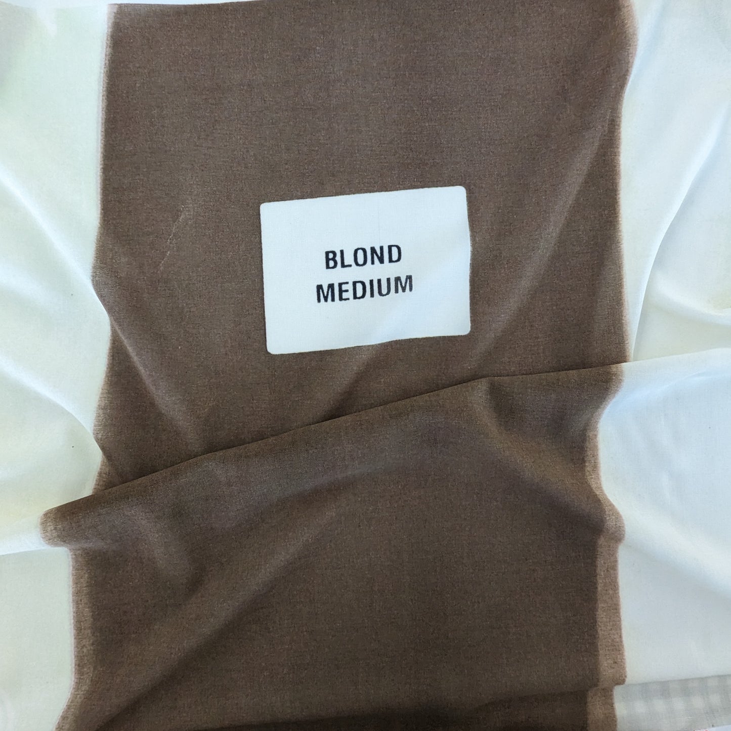 Celine deadstock wool jersey fabric in blonde medium with a white label.
