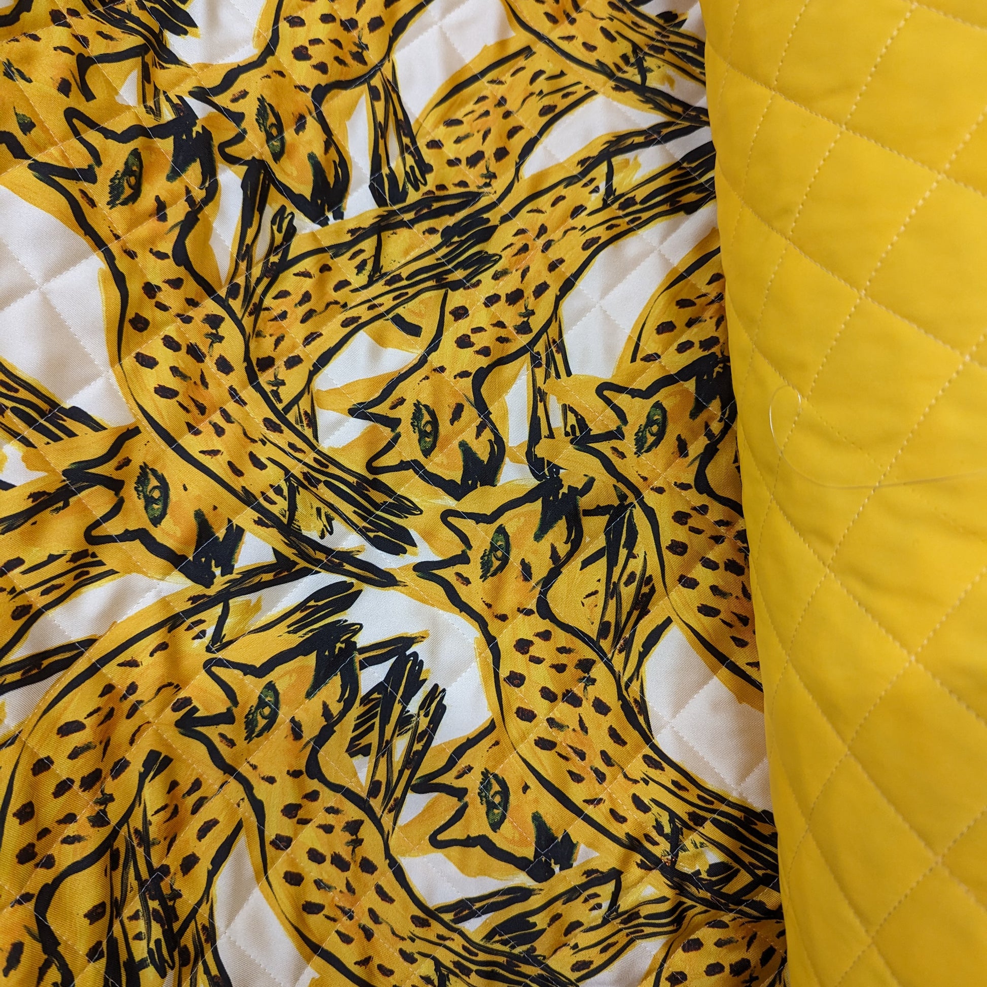 AZ-Factory deadstock quilted fabric: yellow leopard print and plain yellow, both with diamond stitching.