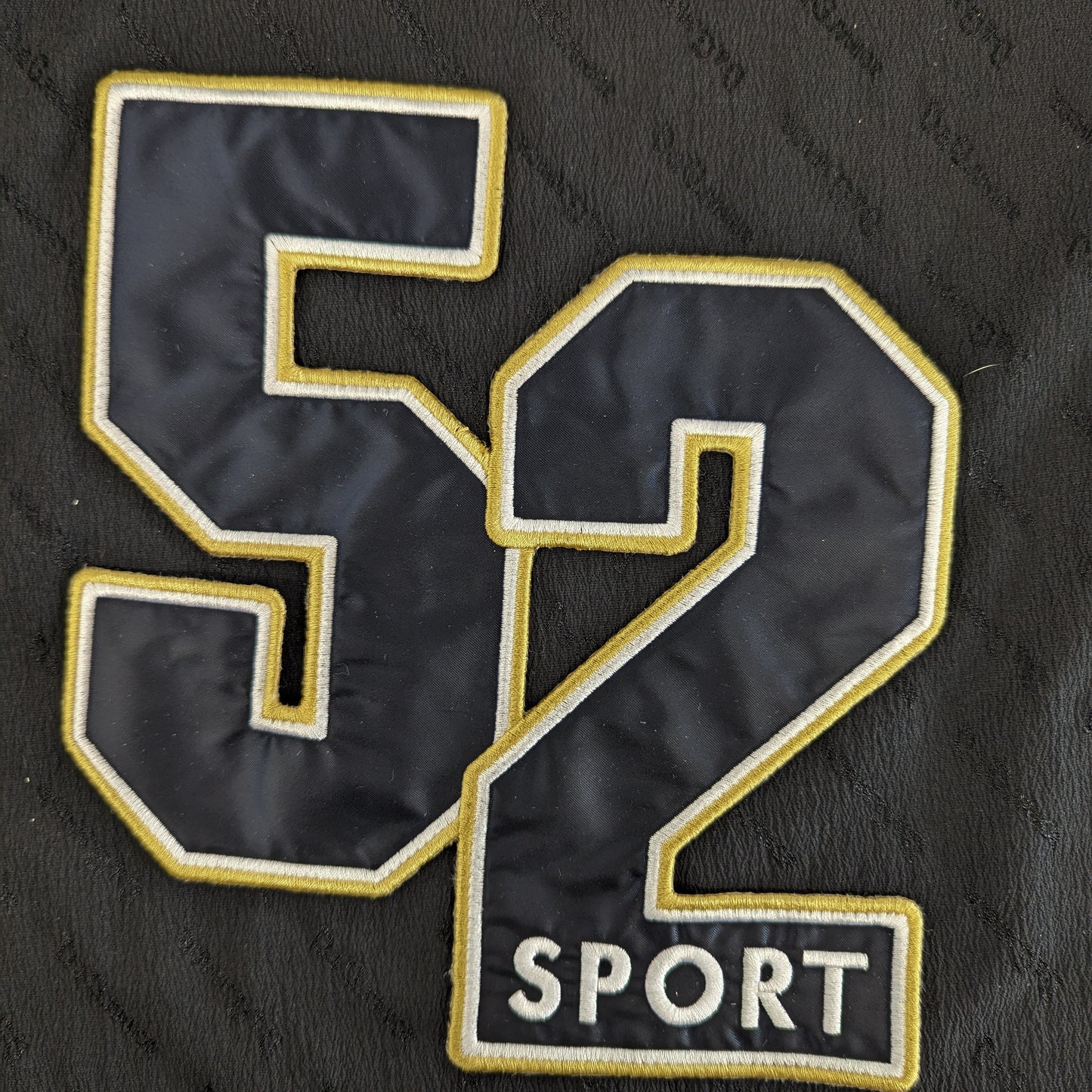 Embroidered D&G patch, black "52 SPORT" design with gold and white outlines, 20x22 cm, mixed fabric.