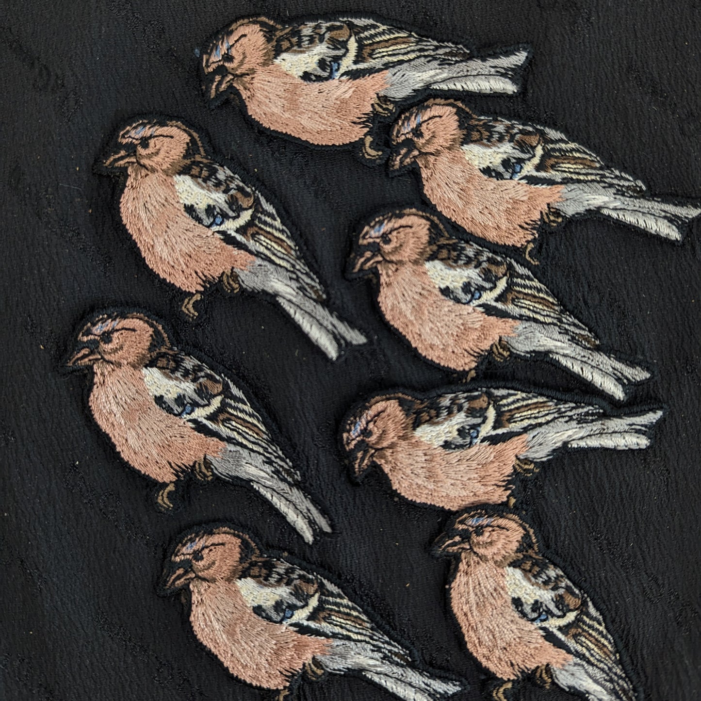 Embroidered designer deadstock patch: 8 cm x 4 cm, featuring multiple brown, white, and grey birds.