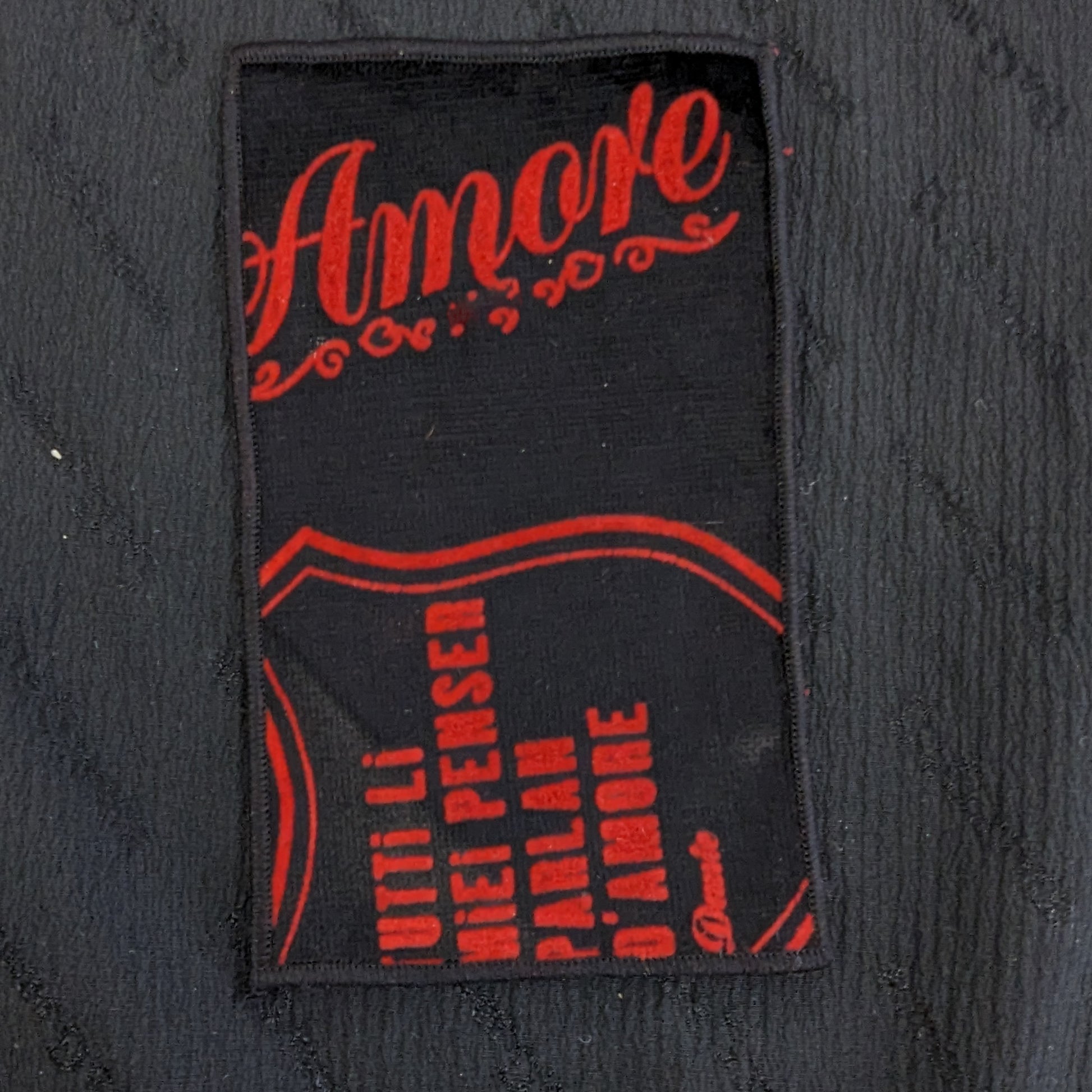 Black velvet patch with "Amore" in red script and Italian text, 12x7cm.