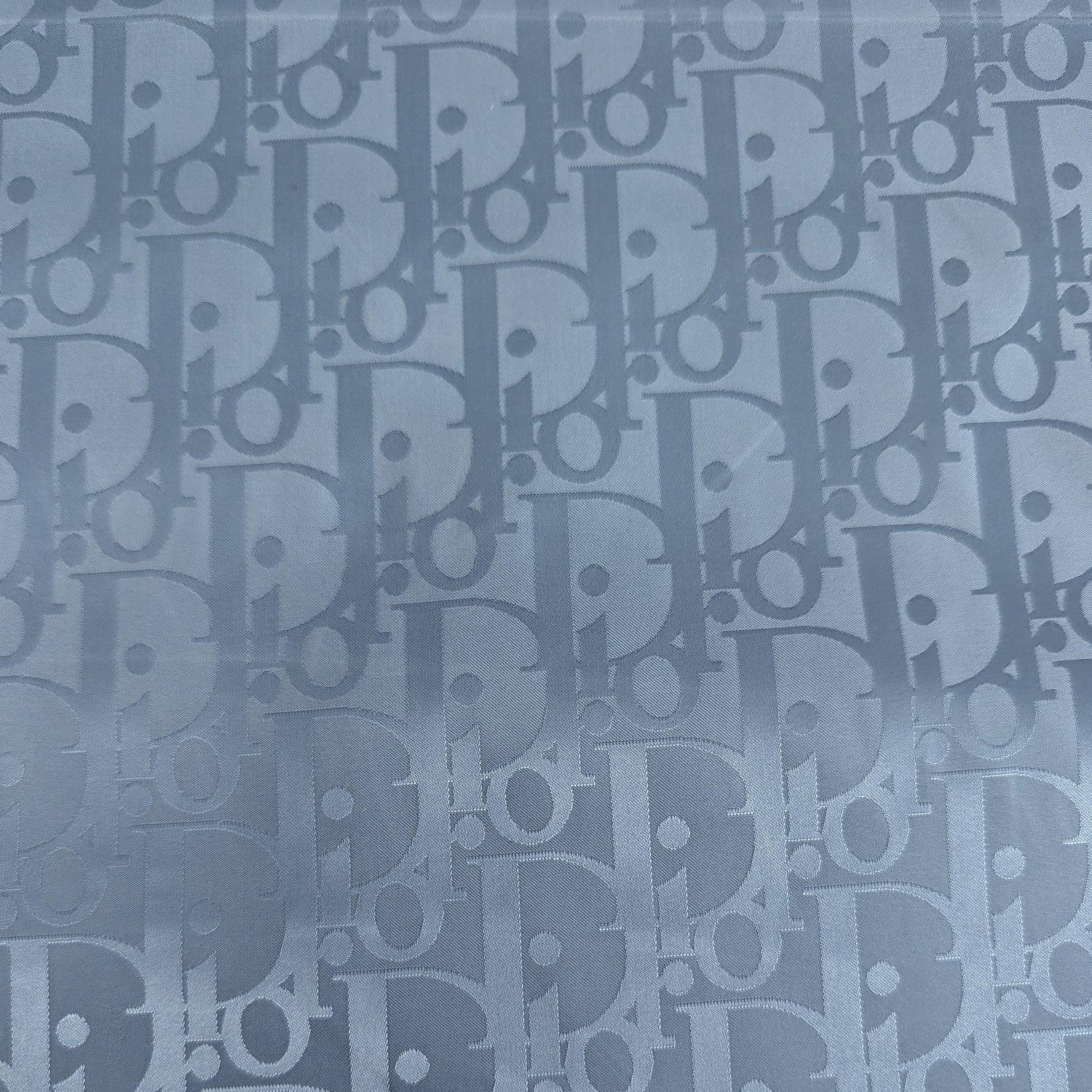 Evertide CD Oblique D##r deadstock nylon fabric, light blue with subtle logo pattern.