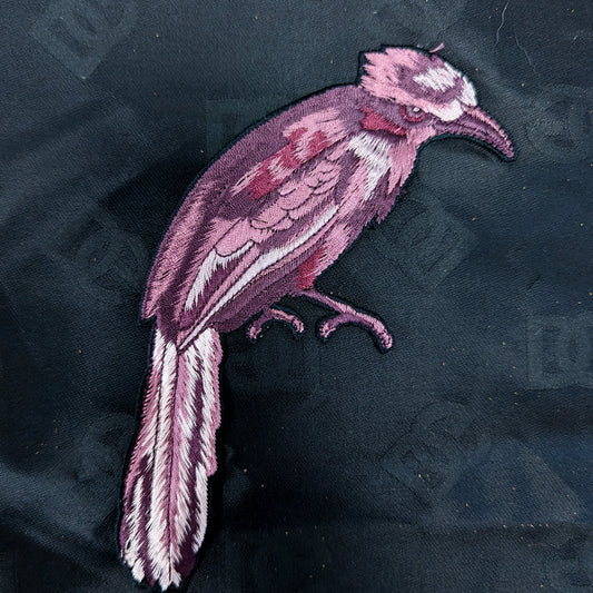 Lila embroidered bird patch, 10x19cm, with detailed feathers and beak on dark fabric.