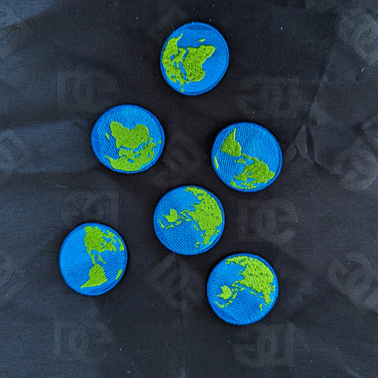 Six round blue and green embroidered Earth patches, 3.5 cm, on a dark fabric background.