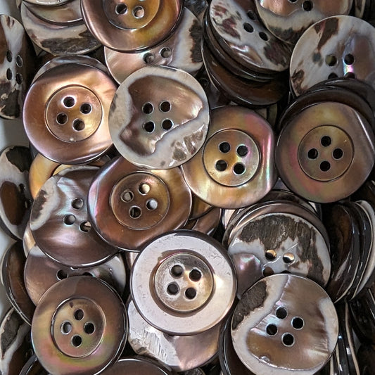 Pile of 2cm round iridescent brown and white mother-of-pearl buttons with four holes and a rim.
