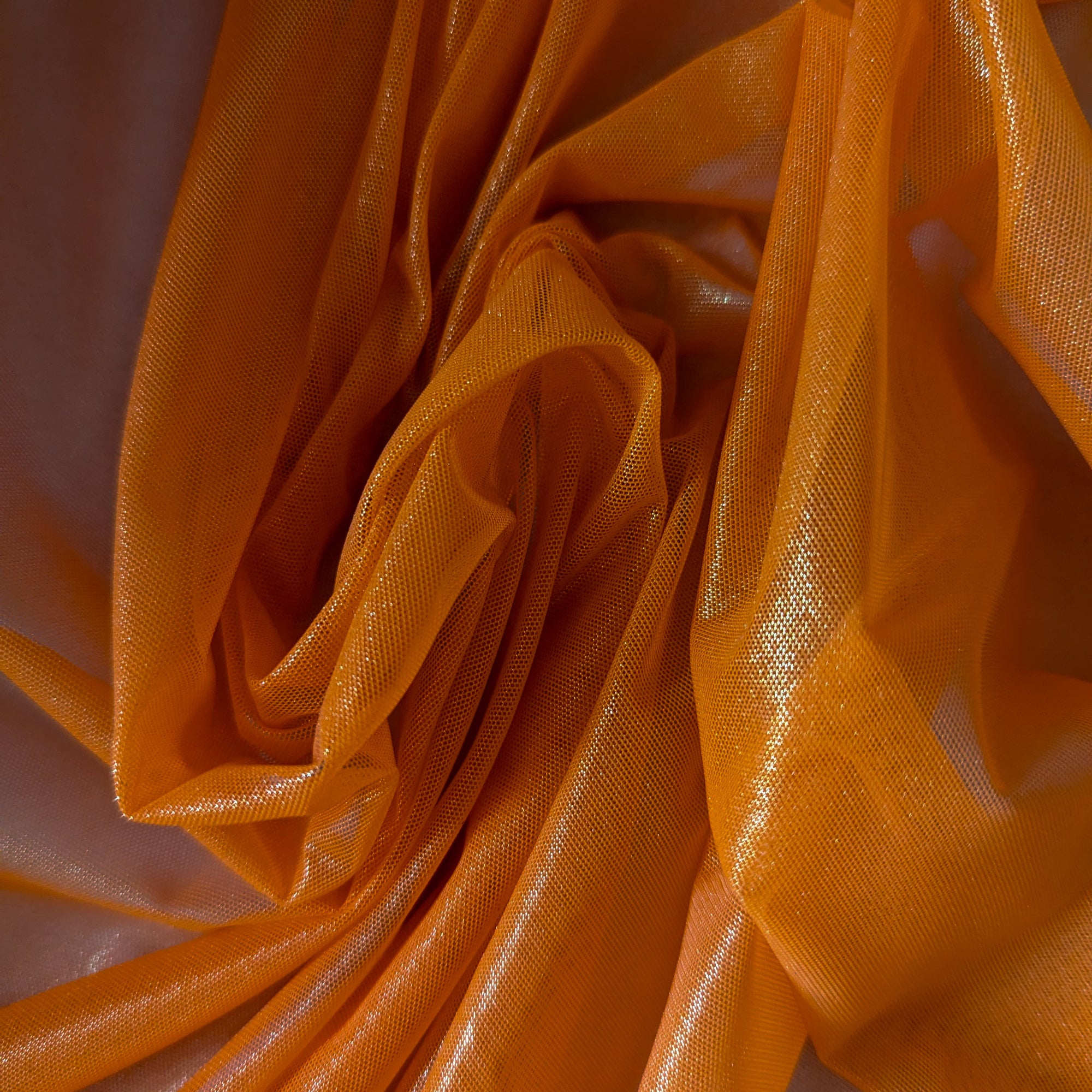 G###i deadstock designer Feintüll fabric in Tangelo, showcasing a metallic sheen and fine, lightweight drape.