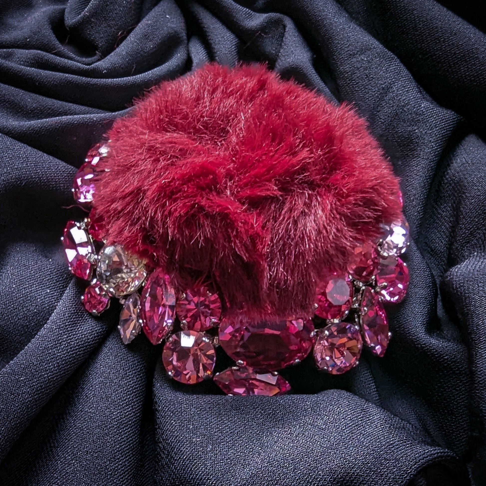 DG ornament: burgundy fur pom-pom surrounded by pink and rose Swarovski crystals.