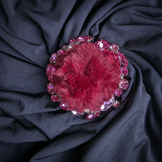 Burgundy fur ornament with pink and rose Swarovski crystals, 7x7cm, on dark fabric.