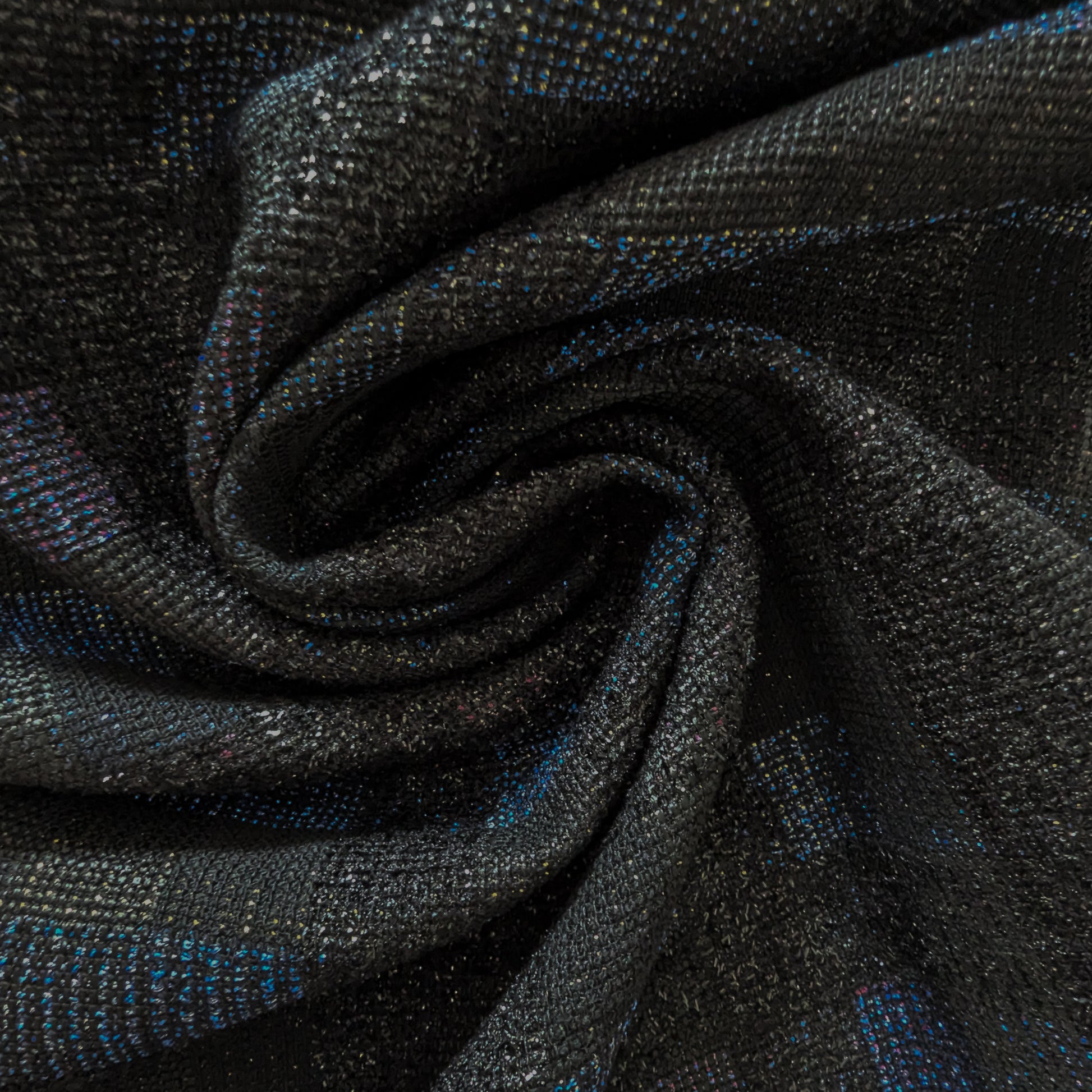 Dark gray doubleface tweed fabric with subtle blue and purple flecks, swirled.