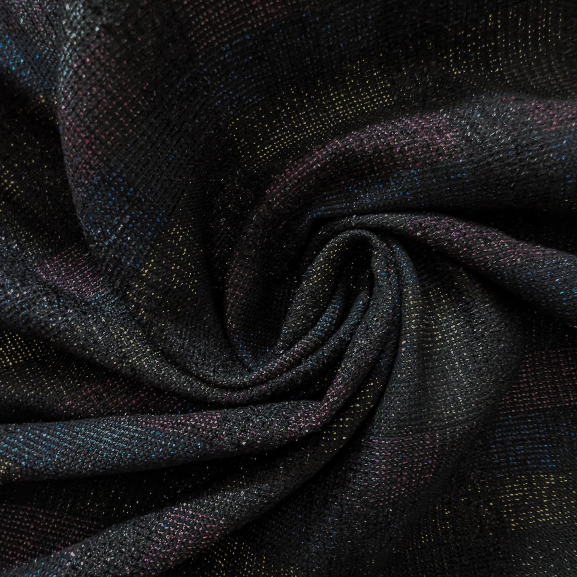 Dark doubleface tweed fabric with subtle colorful flecks, folded in a swirl.