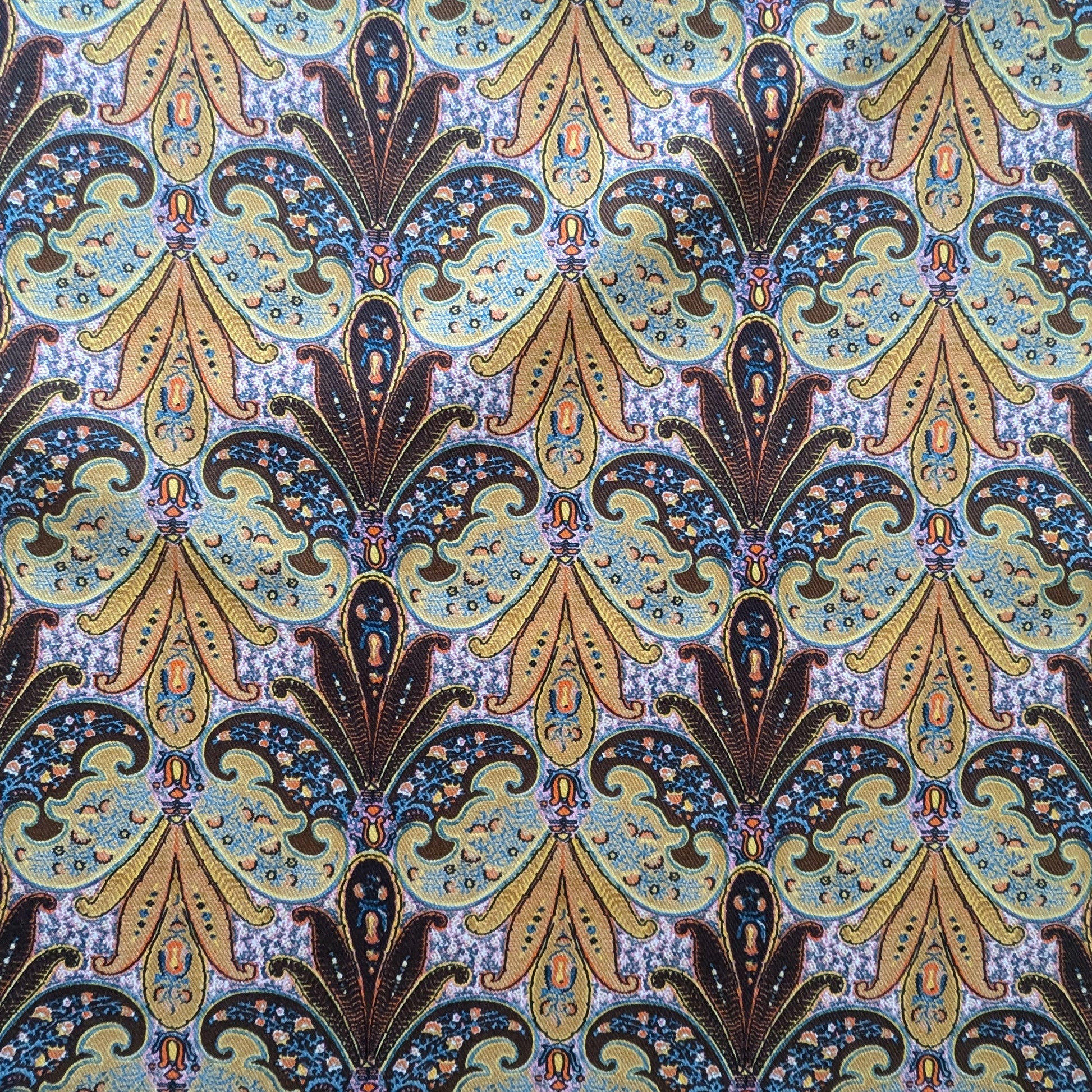 Deadstock E##o denim fabric with intricate blue, gold, and brown paisley pattern.