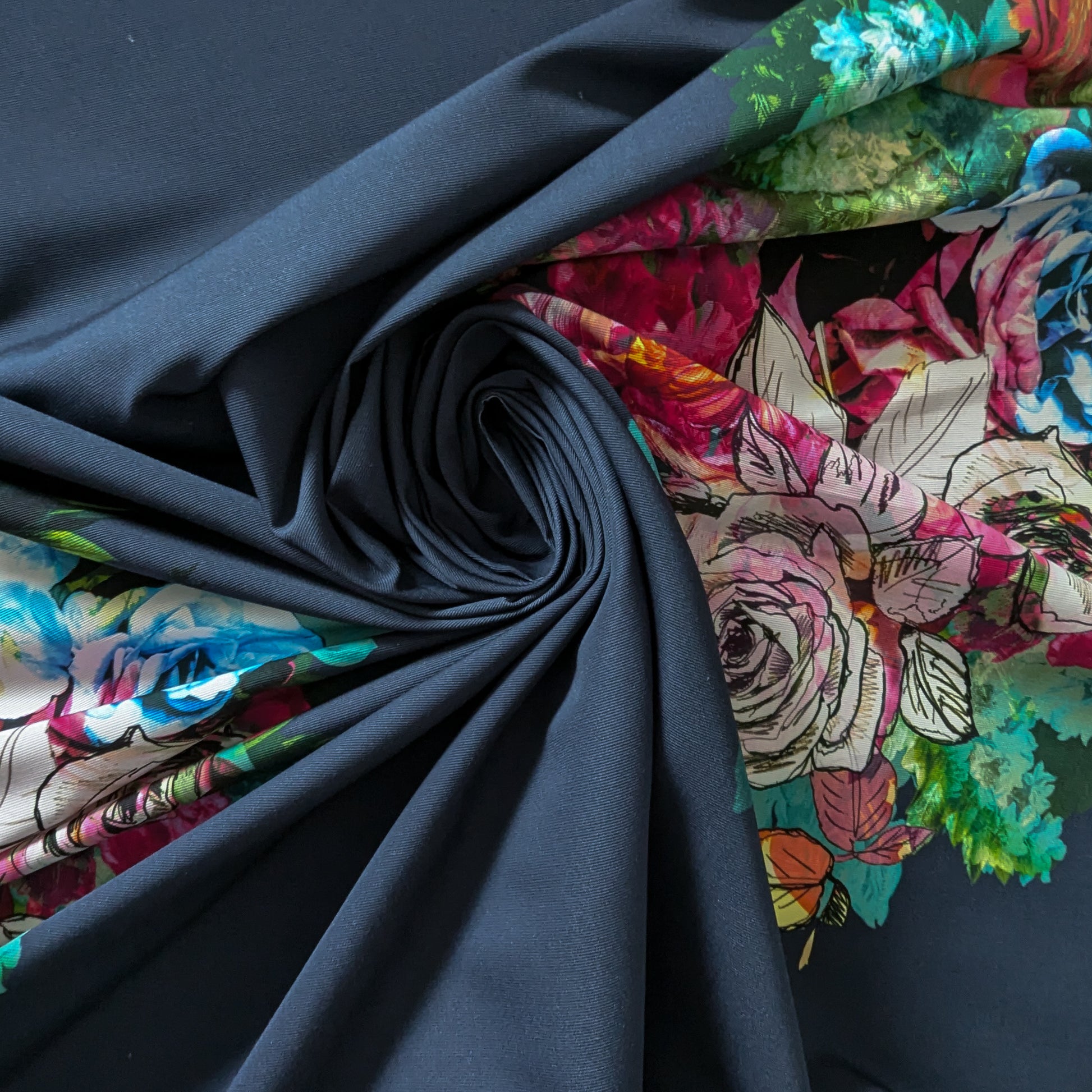 Deadstock denim panel, 150cm wide, in dark blue with vibrant floral print.