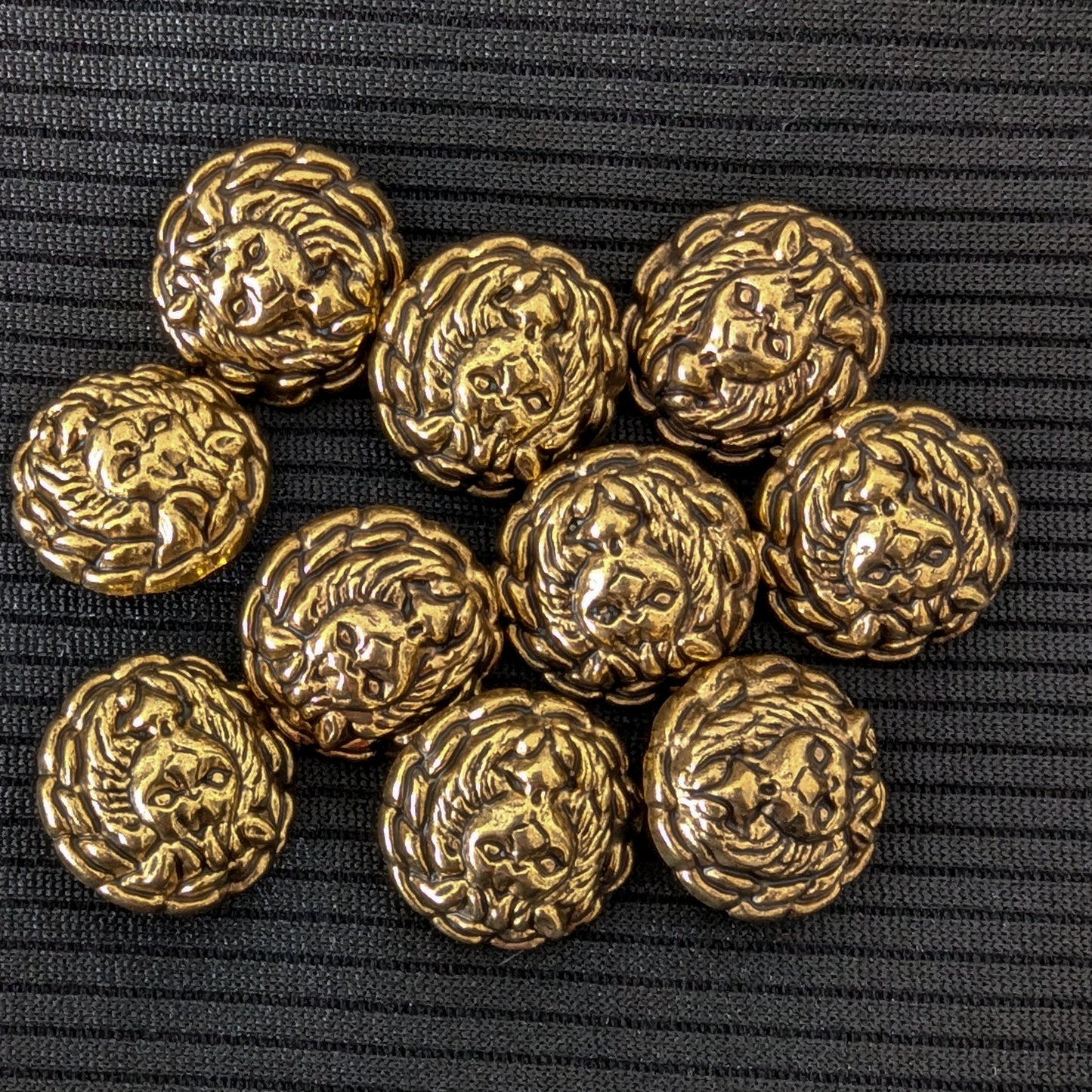 Ten ornate gold brass buttons, 1.7cm, featuring a detailed lion head design on a black background.