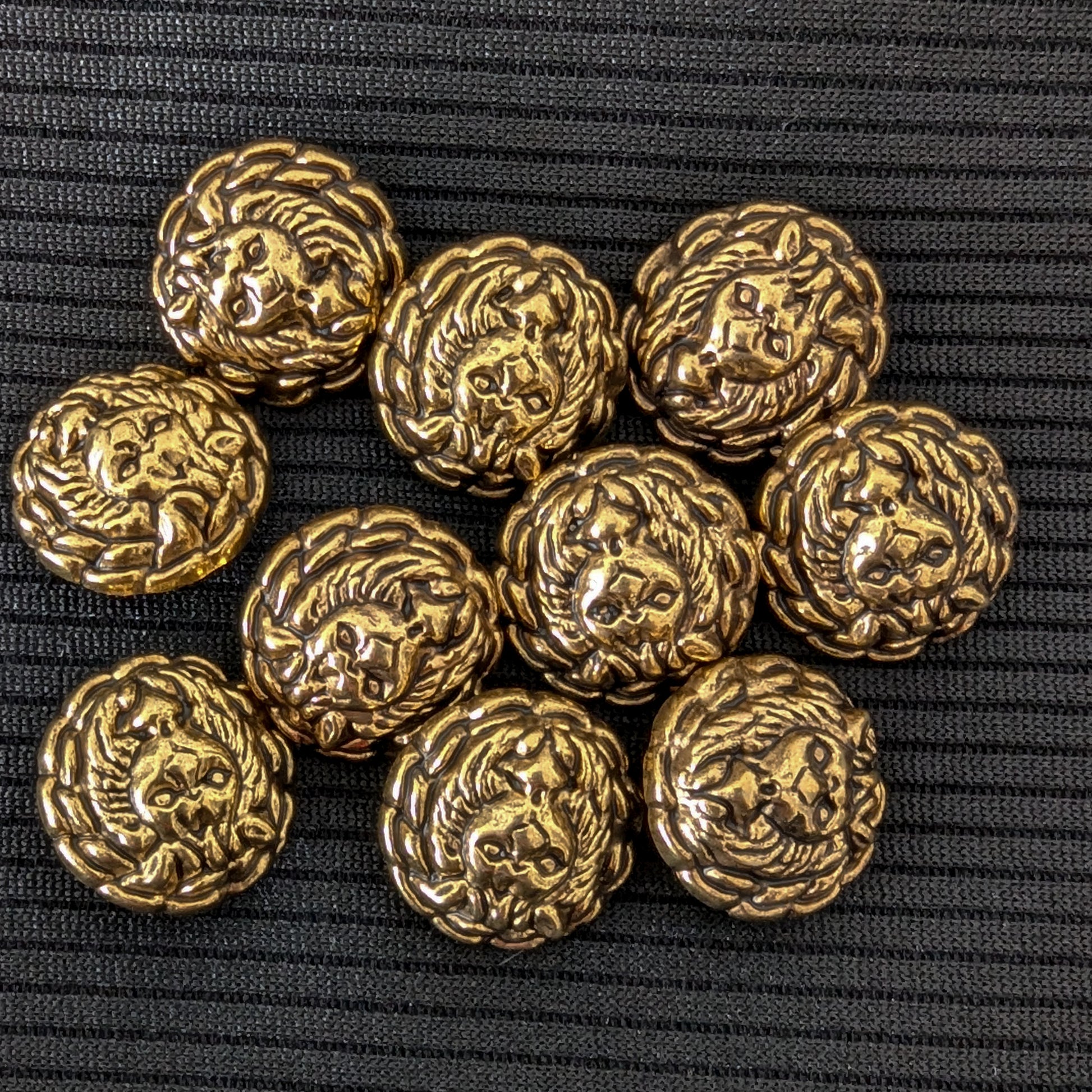 Ten ornate gold brass buttons, 1.7cm, featuring a detailed lion head design on a black background.