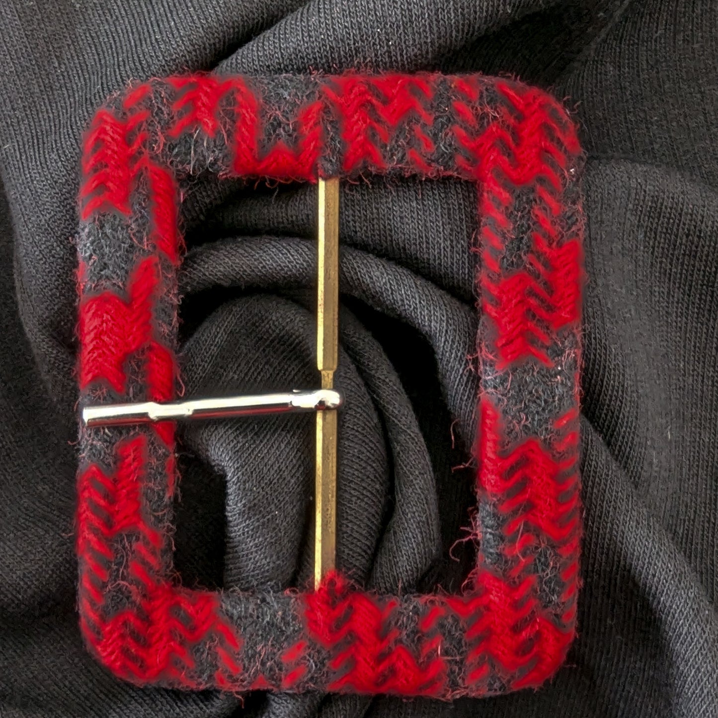 Red and gray chevron textile-covered D&G belt buckle with a gold-tone pin.