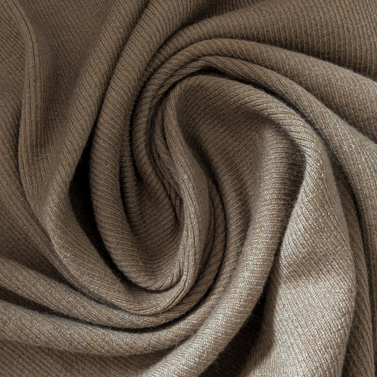 Camel cotton-cashmere rib jersey fabric, soft and uni, folded in a spiral.