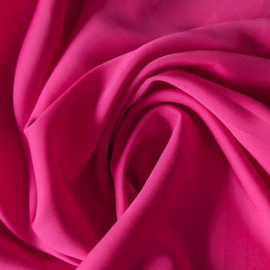 Fuchsia pink linen-cotton blend deadstock fabric, draped in soft folds.