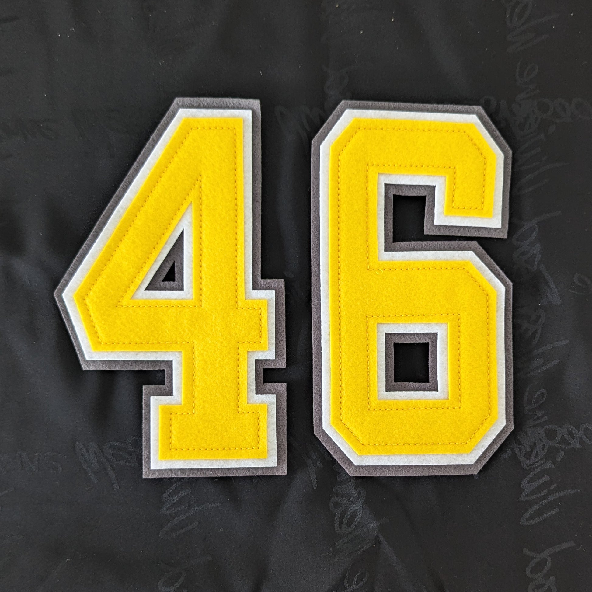 Yellow felt "46" patch with white and grey borders, ideal for creative projects.