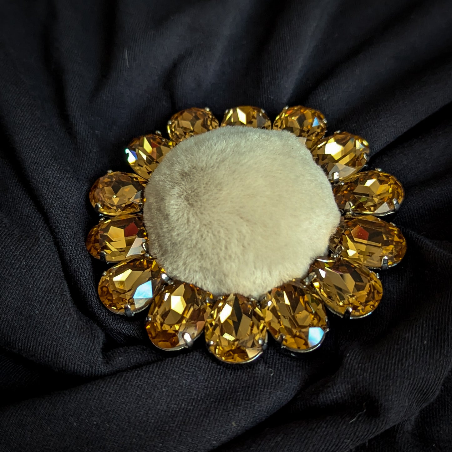 D&G ornate brooch with golden Swarovski crystals and light brown faux fur center.
