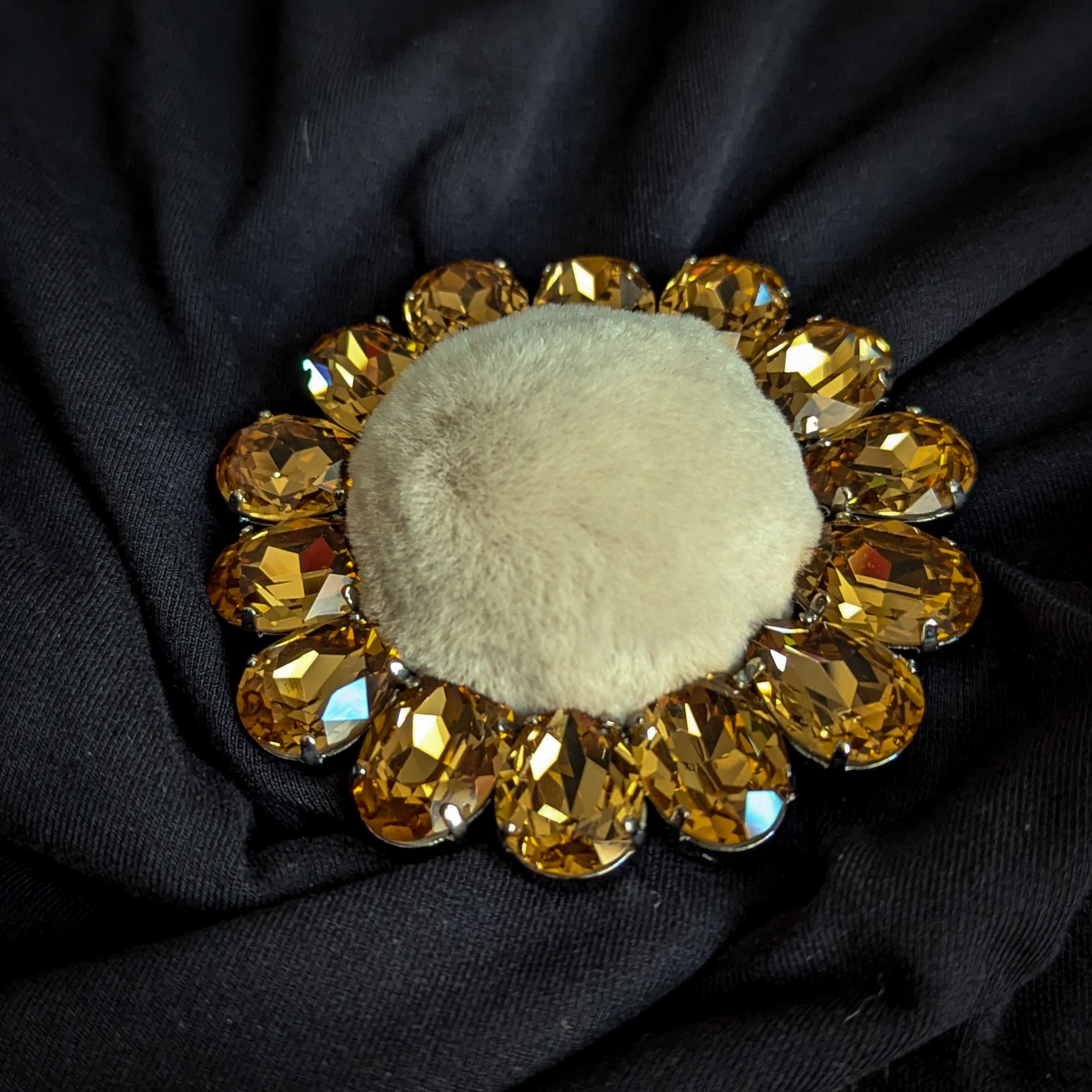 D&G ornate brooch with golden Swarovski crystals and light brown faux fur center.