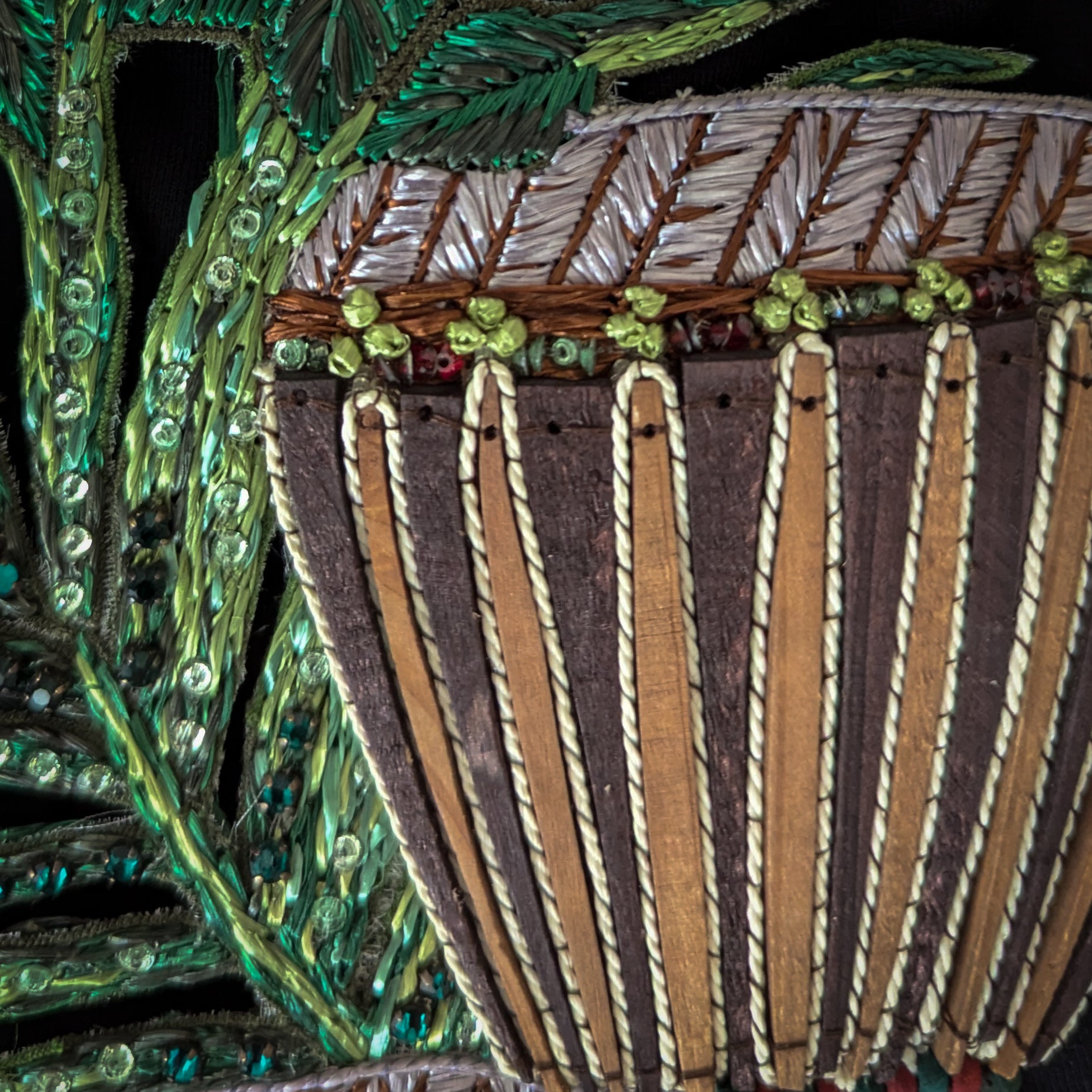 D&G patch with brown wooden drum, intricate embroidery, green sequin leaves, and beaded details.