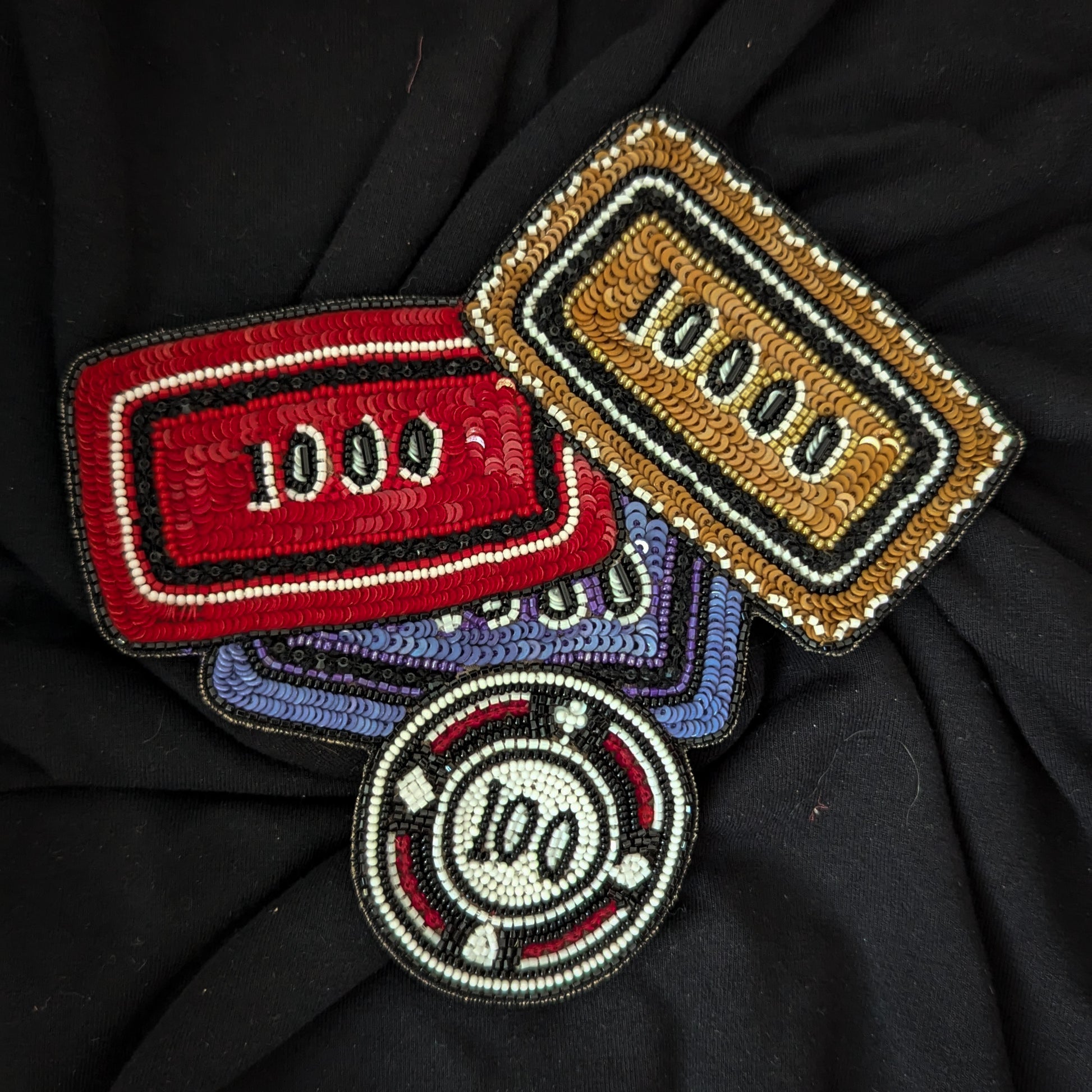 D&G poker chip patches: red, gold, and purple rectangular designs with beads and sequins, plus a round 100 chip.