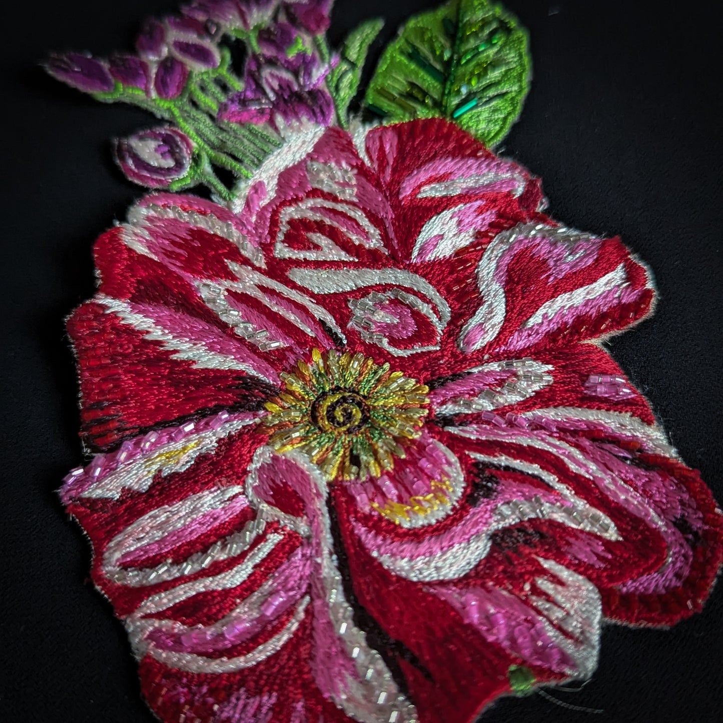 D&G embroidered flower patch, red, pink, and white with pearl beads, green leaves.