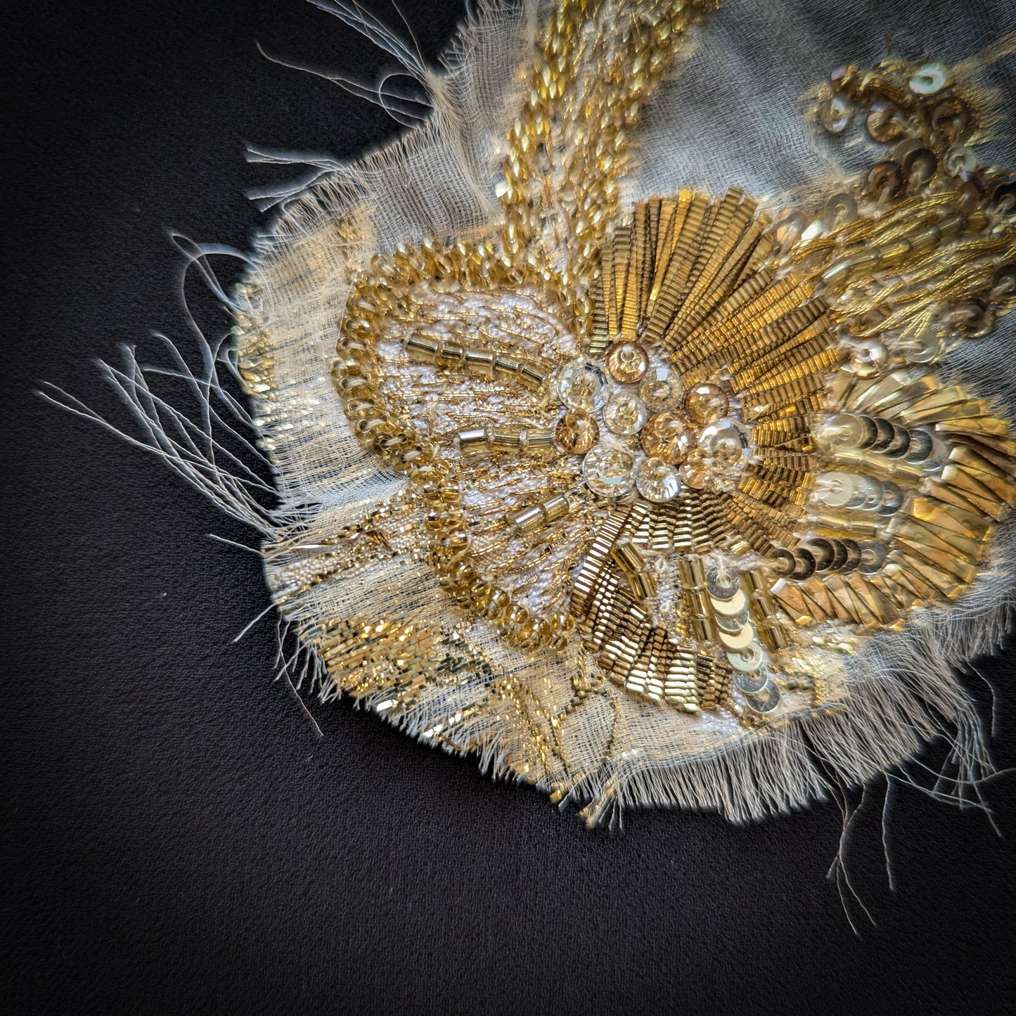 Decorative gold metal embroidery with beads and sequins on a frayed fabric patch, 10x15 cm.